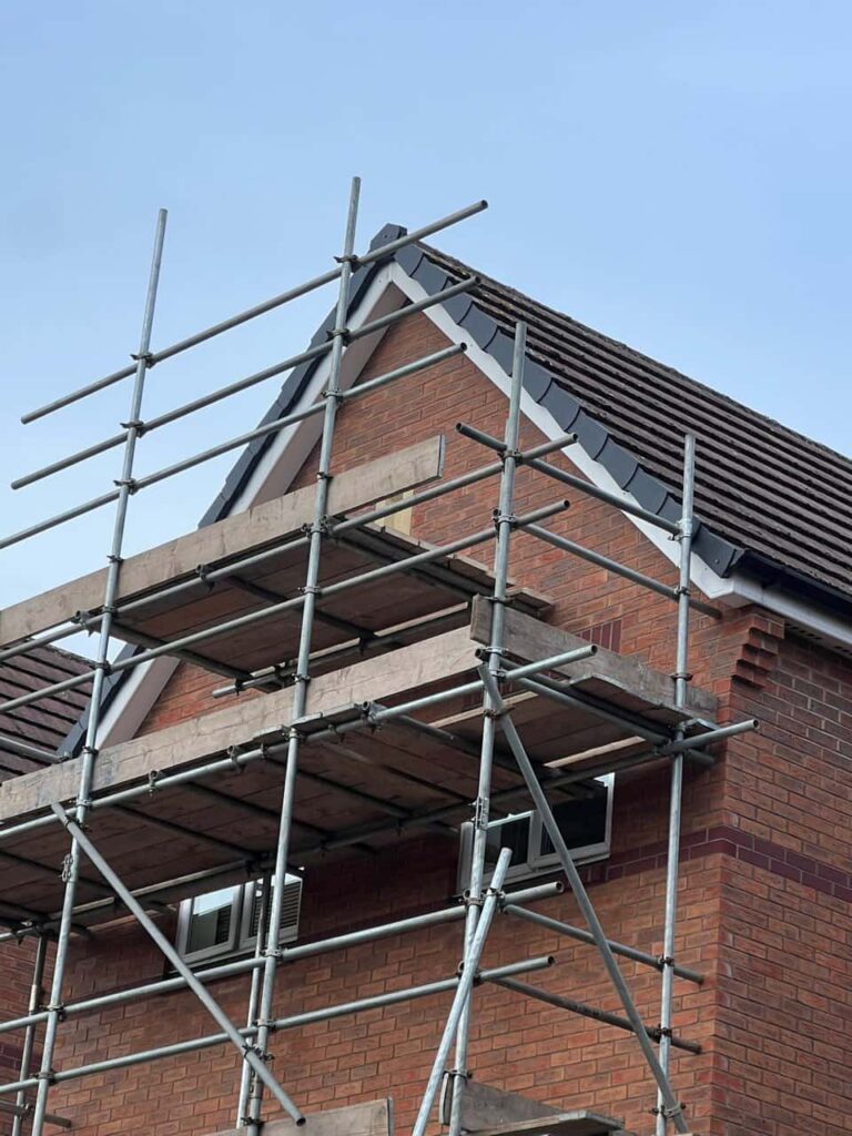 This is a photo of a roof which has just been repaired. There is a scaffold located at the gable end for access onto the roof. Works carried out by Isleham Roofing Repairs