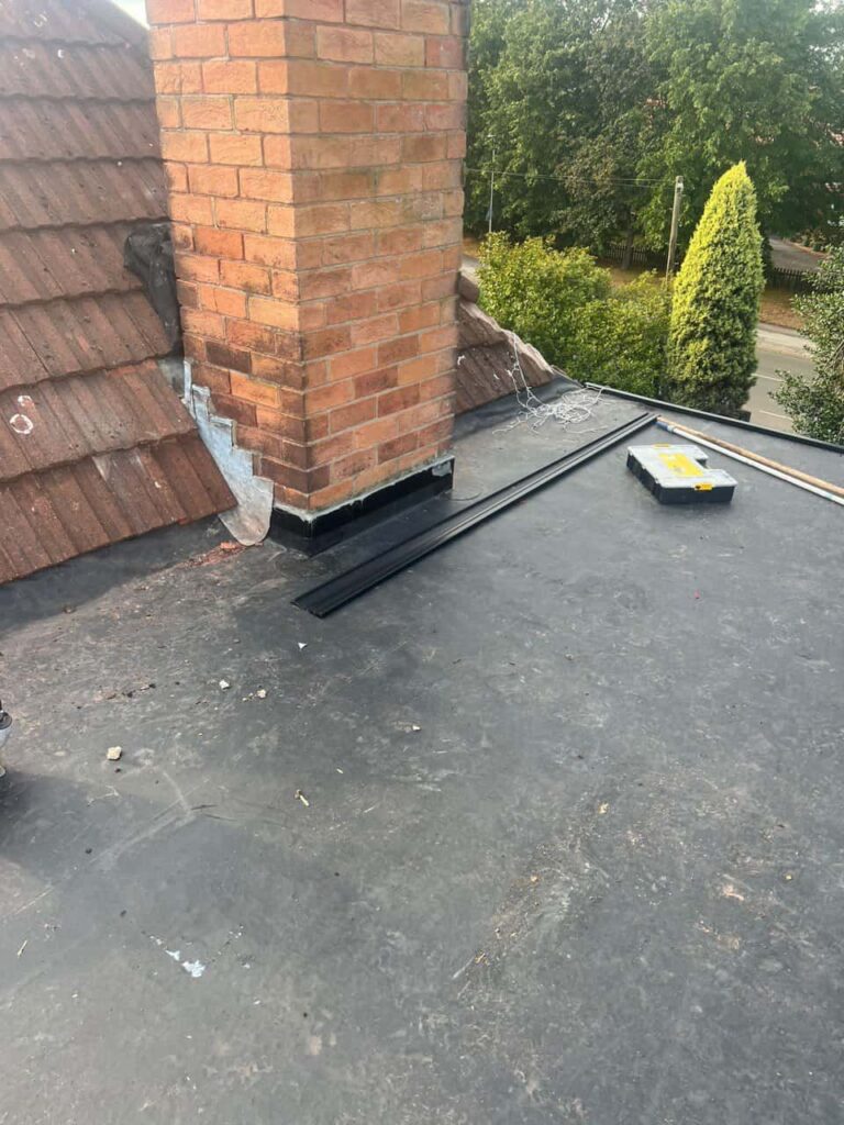 This is a photo of a flat roof which has just been repaired, there is also a chimney stack and some leadwork has also been dressed. Works carried out by Isleham Roofing Repairs